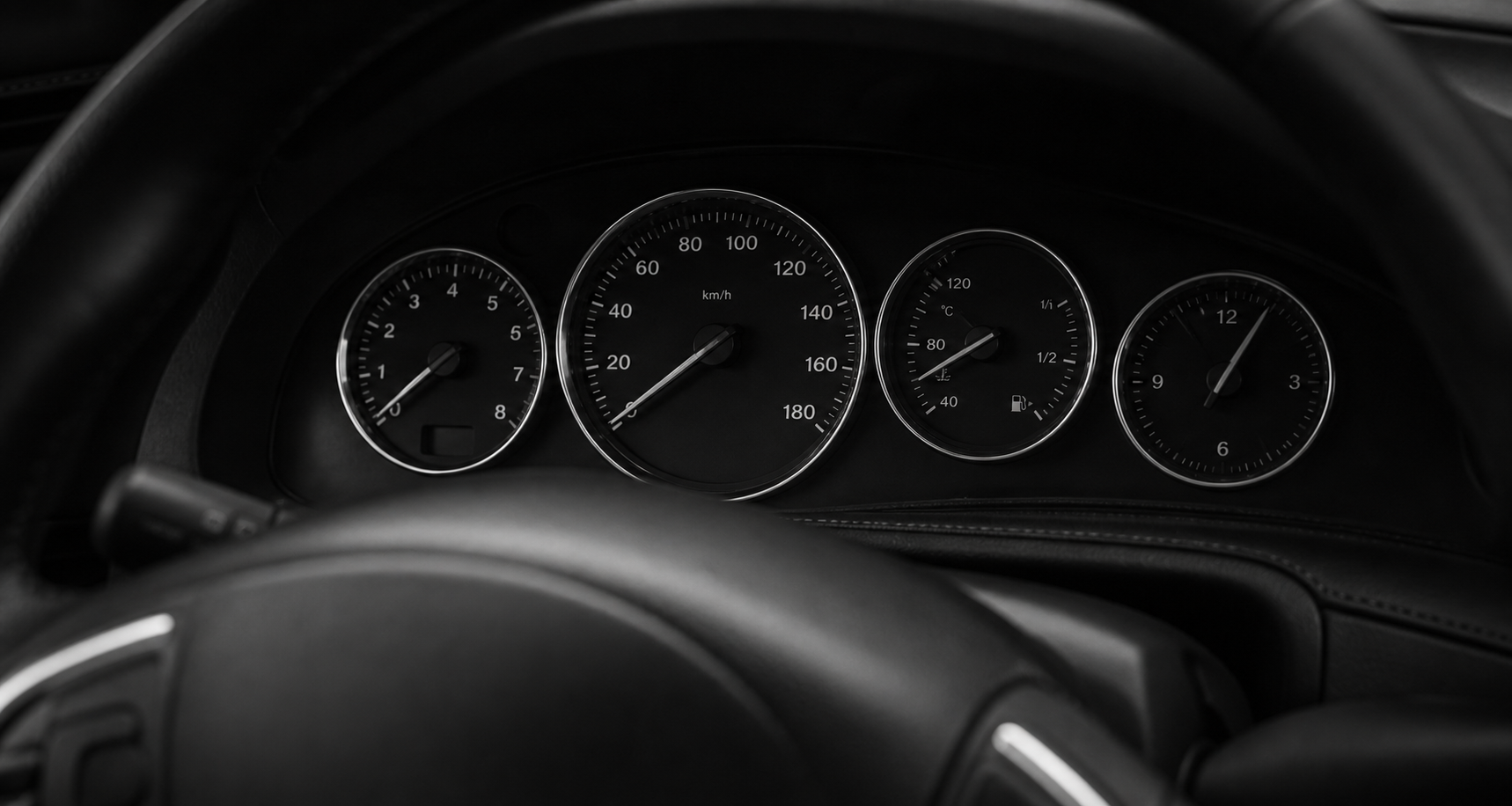 Monochrome close-up of an unbranded instrument cluster.